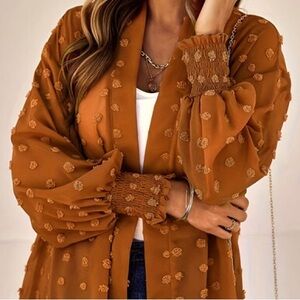 I’m selling this rustic orange lightweight cardigan.
